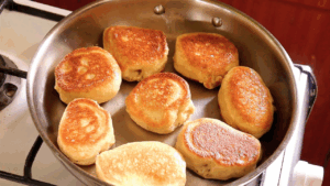 sourdough drop scones done and ready to transfer from the pan to a paper towel-lined platter or plate.