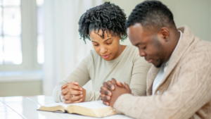 a husband and wife praying together