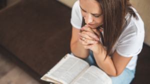 a woman praying the word of God for character transformation