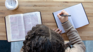 a woman reading the Bible and journaling