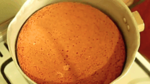 Cake baked without an oven on a gas stove, flipped in the pan to brown the top for a golden finish