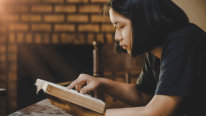 Teen girl reading the Bible during morning quiet time, practicing faith