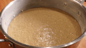 the gluten-free cake batter in a wide greased and dusted pan
