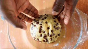 Cookie dough being mixed by hand for easy No-Oven Chocolate Chip Cookies recipe.