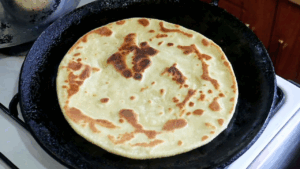 the banana chapati on the pan is now ready