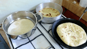 using multiple pans to fry the chapatis to hasten the process