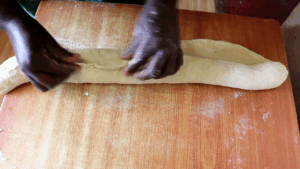 rolling the dough into a rope and sealing in the oil to help form layers in the chapatis