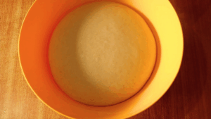 Fully risen sourdough dough after overnight bulk fermentation, showing a light, airy texture ready for shaping.