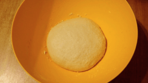 Soft no-oven sourdough sandwich bread dough in a bowl, ready to rest for 20 minutes before kneading.
