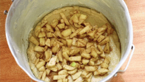 Layer the remaining apples, then finish with the smallest portion of dough on top.