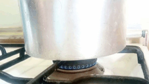 Covered cake pan baking on very low flame on the stovetop